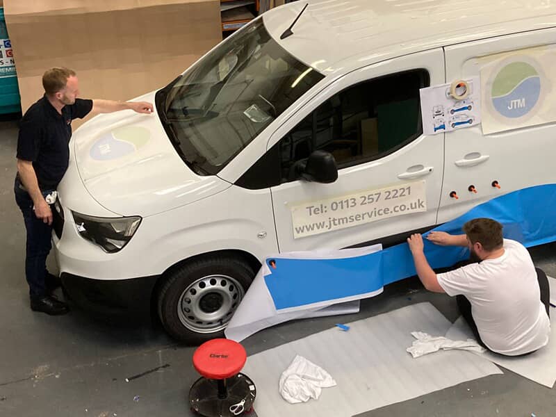 An image of the installation of the commercial laundry van graphics.